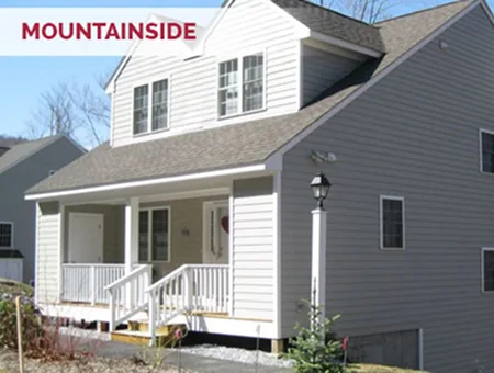 Two-story gray Black Diamond home in Mountainside neighborhood with covered front porch and side chimney