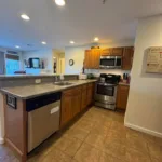 Kitchen with oak cabinets, breakfast bar, stainless range, microwave, and dishwasher at JJ's Lodge 862